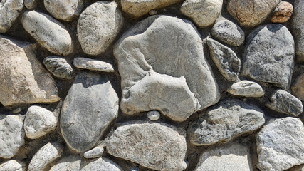 Modern eco stone cladding of the facade of buildings and interiors of houses walls made of old, rough natural eco stone.