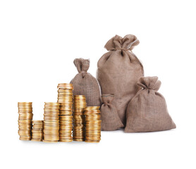 Wealth. Stacked coins and burlap bags isolated on white
