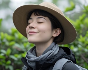 Peaceful Woman Enjoying Nature with Eyes Closed and Wide-Brim Hat