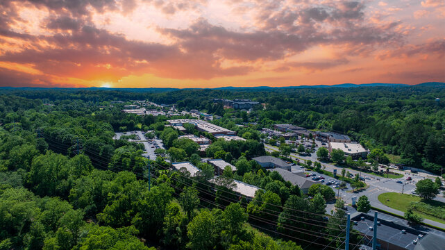 aerial shot of office buildings, retail stores and restaurants and lush green trees in Canton Georgia USA
