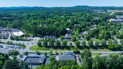 aerial shot of office buildings, retail stores and restaurants and lush green trees in Canton...