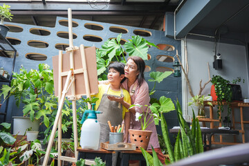 Asian Kid Artist and Mom Drawing with Colorful Paints at Home, Mother and Son Painting Together in...
