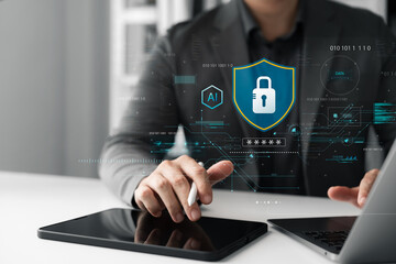 Businessman using tablet and laptop for data protection with cybersecurity lock icon. AI technology, network safety, encryption, privacy, and secure access.
