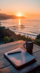 Sunrise over ocean, journal and coffee