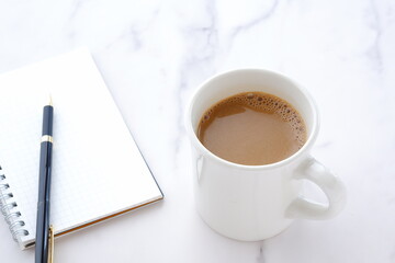 Memo Pad and pen with cup of Coffee
