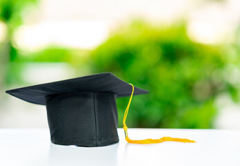 A graduation cap with a yellow tassel.