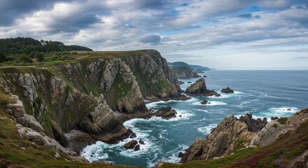 Obraz premium Panoramic Coastal Seascape with Rocky Cliffs and Cloudy Blue Sky Photo