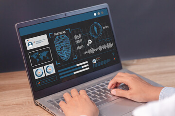 Man using a laptop to create convincing fake image, video and audio recording. Deepfake and...