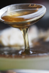 Honey being drizzled from a spoon in close up shot