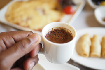 Enjoying turkish coffee during breakfast gathering
