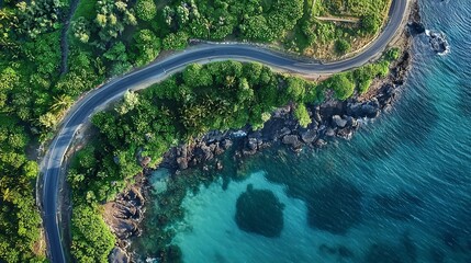 Beautiful coastal road captured from above, winding along the ocean's edge.