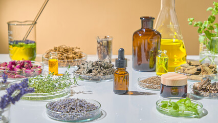 Natural essential oil display with amber bottles, green extracts, dried flowers, and lab tools for herbal research. Advertising photo for product with ingredient from herbal
