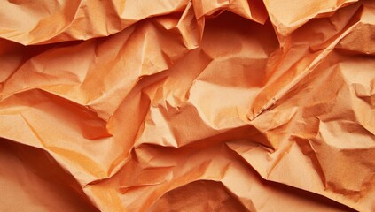 Close-up of crumpled, light orange paper; texture shows deep folds and creases, creating a dramatic, abstract surface