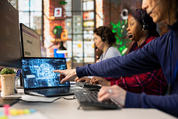Call center employee using AI chatbot at office desk to reply to common customer queries, close up....