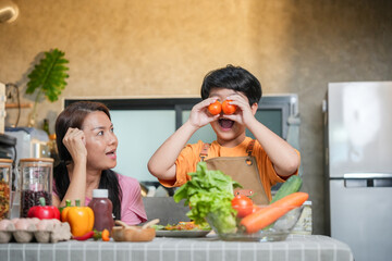 Cheerful Child Boy and Mom Enjoy Cooking Time at Home, Mother and Son Preparing Healthy Meal Together, Asian Family Cooking Homemade Sandwiches in Kitchen