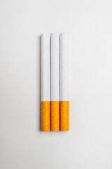 Cigarettes, rolled tobacco in paper with a filter tube, isolated on a white background. No or quit smoking, a bad habit, and unhealthy