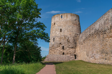 View of the Izborsk fortress wall and the Vyshka Tower on a sunny summer day, Izborsk, Pechersk district, Pskov region, Russia