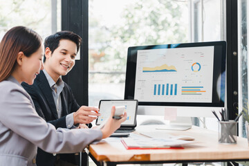 Fototapeta premium Business professionals discussing data analysis with dashboard on computer screen in modern office, teamwork and collaboration for project success, cheerful atmosphere and natural light