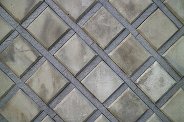 A close-up view of a textured brick wall with various shades of reddish-brown, showcasing the rough surface and distinct patterns of the bricks. For background, texture, or in 3D design applications.