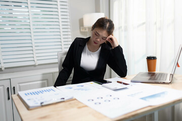 A stressed businesswoman sits alone in an office, overwhelmed by deadlines and corporate pressure,...