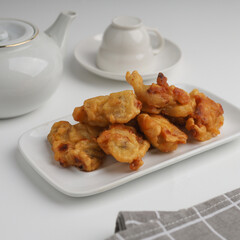 Banana fritters in a plate on white background