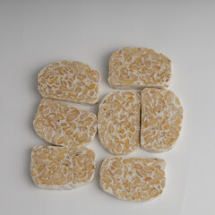 Raw tempeh on white background