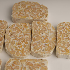 Raw tempeh on white background
