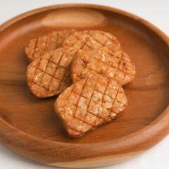 Fried tempeh on in a plate on white background
