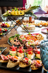 A festive table offers colorful appetizers, fruits, and desserts for guests to enjoy