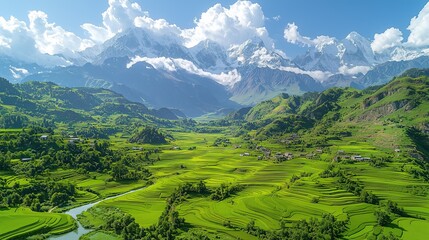 Obraz premium Captivating Aerial View of Lush Green Terraced Fields and Villages: Dramatic Snow-Capped Mountains Under a Bright Blue Sky 