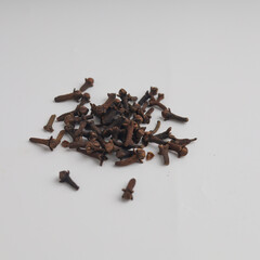Heap of cloves on wooden background