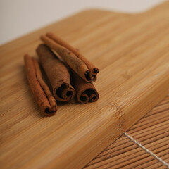 Cinnamon sticks on wooden board 