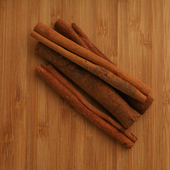 Cinnamon sticks on wooden board 