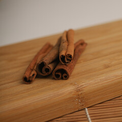 Cinnamon sticks on wooden board 