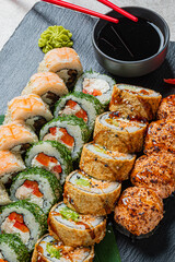 Colorful sushi rolls artfully arranged with wasabi and soy sauce