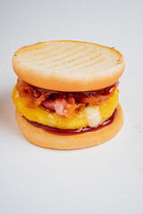A sandwich bursting with flavors: crispy bacon, grilled pineapple, and savory sauce on toast