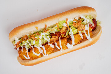 Savory hot dog loaded with crunchy lettuce and golden fried onions, drizzled with creamy sauce