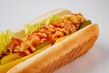 Savory hot dog carefully arranged with lettuce, pickles, and a drizzle of sauce for flavor