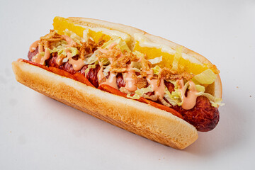 Delicious hot dog topped with lettuce, sauces, and pineapple—perfect for street food fans!