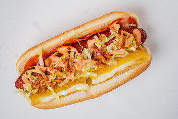 Gourmet hot dog topped uniquely, waiting for you at a casual eatery. Enjoy the flavor!