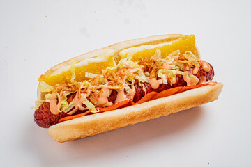 A tasty hot dog with crispy lettuce, zesty sauces, and a toasted bun invites indulgence