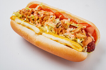 A delicious hot dog features grilled sausage, crisp lettuce, sliced tomatoes, and savory sauce