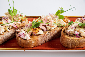 Deliciously topped rustic bread showcases a mix of savory ingredients and vibrant garnishes