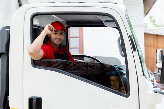 Professional services logistic moving house team concept, Indian or Latin driver and Caucasian worker in uniform thums up for good services sitting in cargo truck, plan deliver furniture to new house