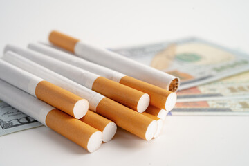 Cigarette on US dollar banknotes, cost, trading, marketing and production, No smoking.