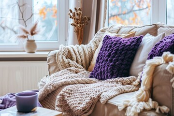A warm inviting nook with a focus on knitted blankets and pillows showcasing comfort and handicraft