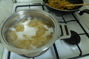pasta cooking in a stainless steel pot