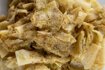 close-up of cabbage noodles sprinkled with black pepper