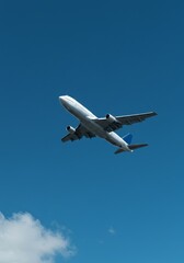 Photo An Airplane Flying High Above Blue Sky With White Clouds
