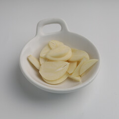 Garlic in a plate on white background